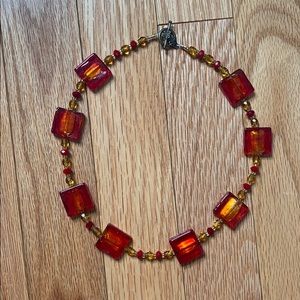 Red square and beaded necklace